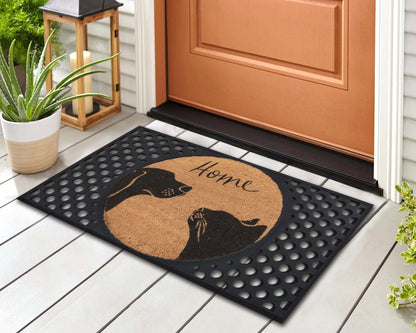 Doormat with dog design and 'Home' text on a wooden floor outside a door.